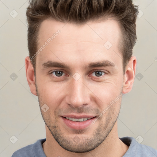 Joyful white young-adult male with short  brown hair and grey eyes