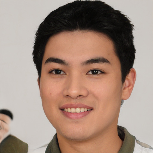 Joyful asian young-adult male with short  black hair and brown eyes