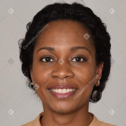 Joyful black young-adult female with medium  brown hair and brown eyes