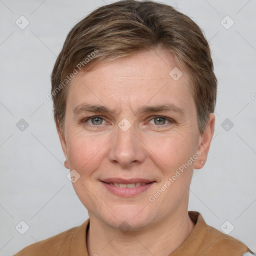 Joyful white adult female with short  brown hair and grey eyes