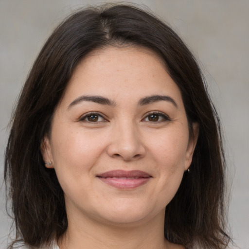 Joyful white young-adult female with medium  brown hair and brown eyes