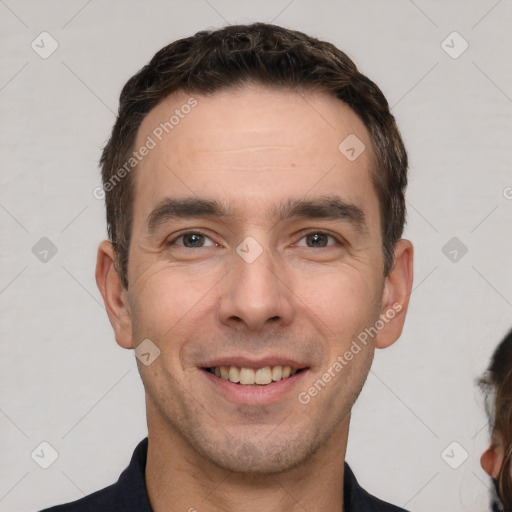 Joyful white young-adult male with short  brown hair and brown eyes