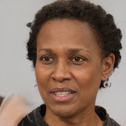 Joyful black adult female with short  brown hair and brown eyes