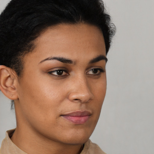 Joyful latino young-adult female with short  brown hair and brown eyes