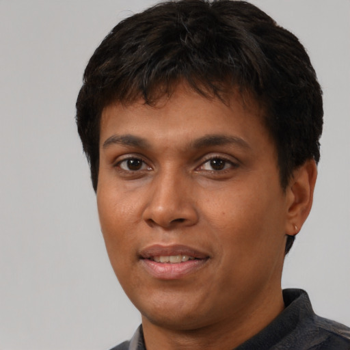 Joyful black young-adult male with short  brown hair and brown eyes