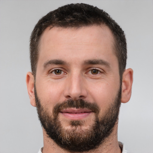 Joyful white young-adult male with short  brown hair and brown eyes