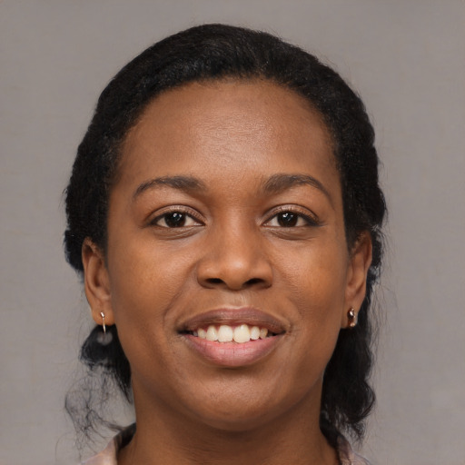 Joyful black young-adult female with medium  brown hair and brown eyes