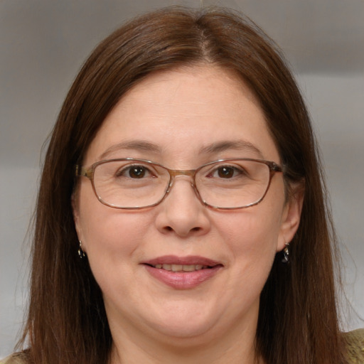 Joyful white adult female with long  brown hair and brown eyes