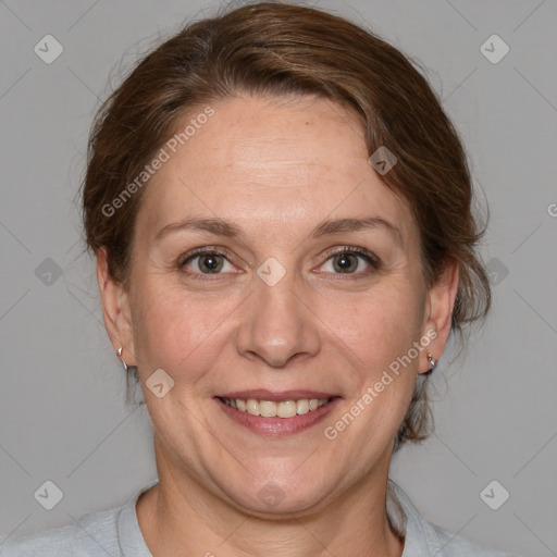 Joyful white adult female with medium  brown hair and grey eyes