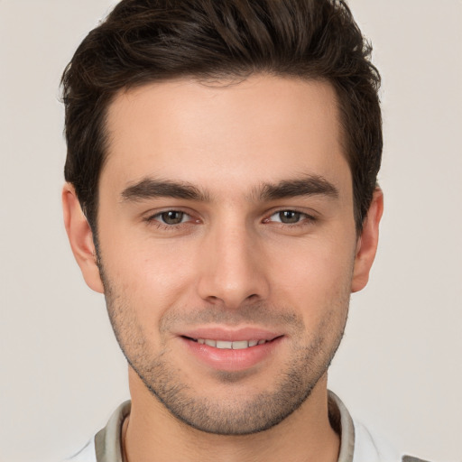 Joyful white young-adult male with short  brown hair and brown eyes