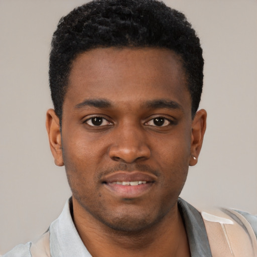 Joyful black young-adult male with short  brown hair and brown eyes