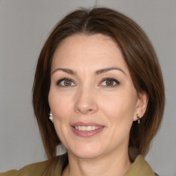 Joyful white adult female with medium  brown hair and brown eyes