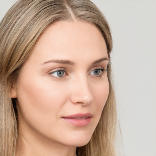 Neutral white young-adult female with long  brown hair and green eyes