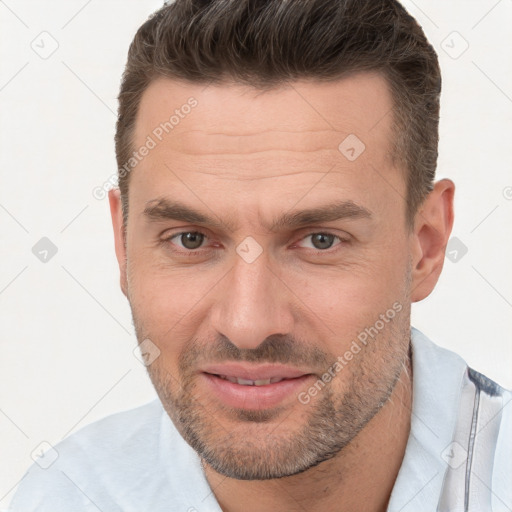 Joyful white adult male with short  brown hair and brown eyes