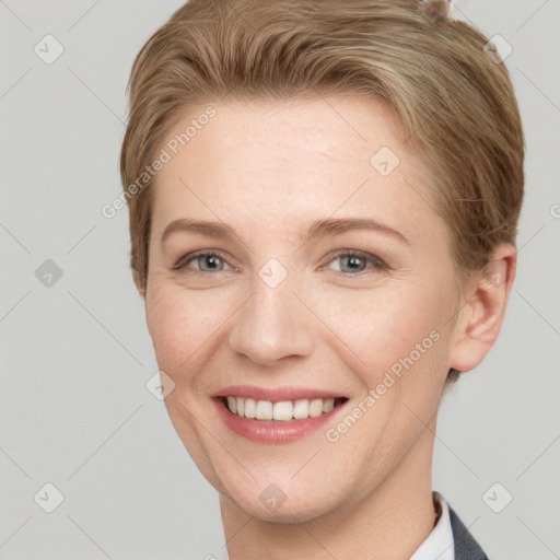 Joyful white young-adult female with short  brown hair and grey eyes