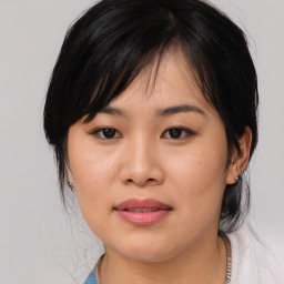 Joyful asian young-adult female with medium  black hair and brown eyes