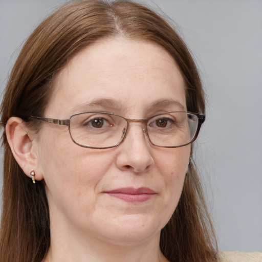 Joyful white adult female with long  brown hair and blue eyes