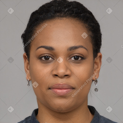 Joyful black young-adult female with short  black hair and brown eyes