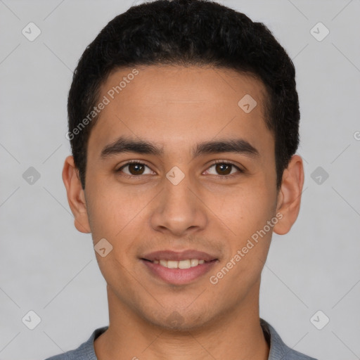 Joyful white young-adult male with short  black hair and brown eyes