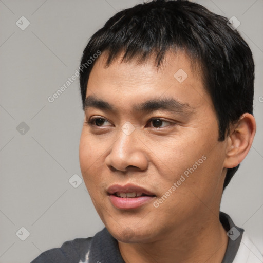 Joyful asian young-adult male with short  black hair and brown eyes