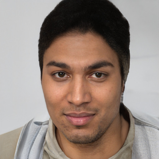 Joyful latino young-adult male with short  brown hair and brown eyes