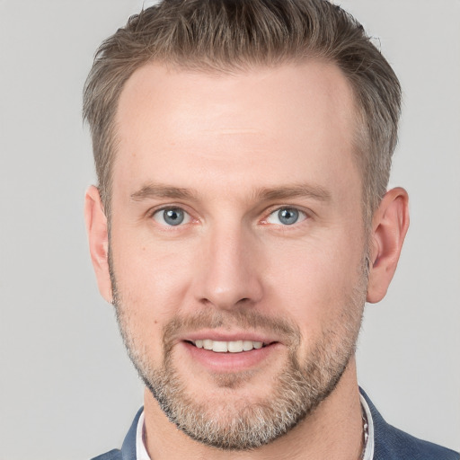 Joyful white adult male with short  brown hair and grey eyes