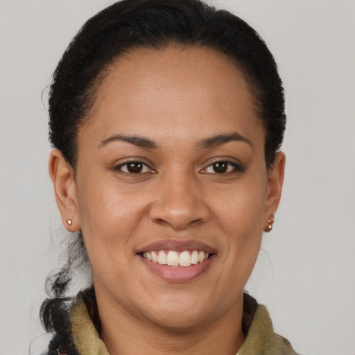 Joyful black young-adult female with short  brown hair and brown eyes