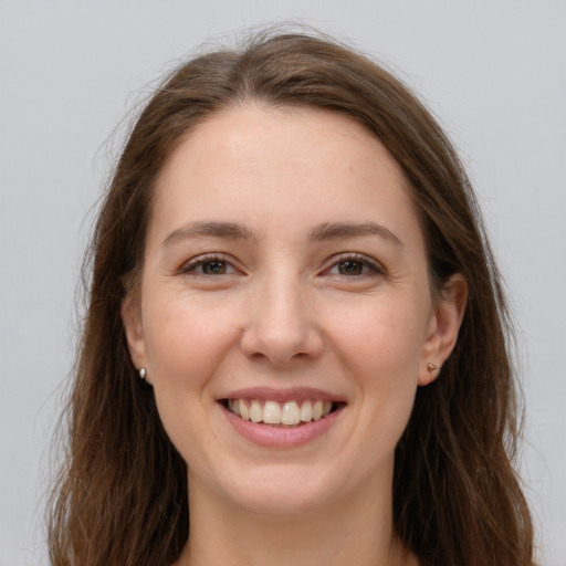 Joyful white young-adult female with long  brown hair and grey eyes