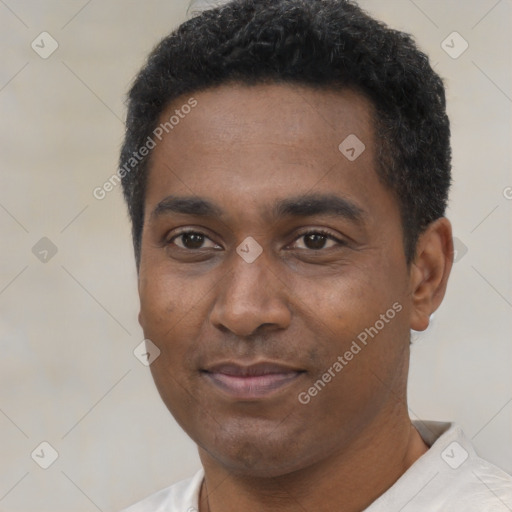 Joyful black young-adult male with short  black hair and brown eyes