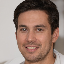 Joyful white adult male with short  brown hair and brown eyes