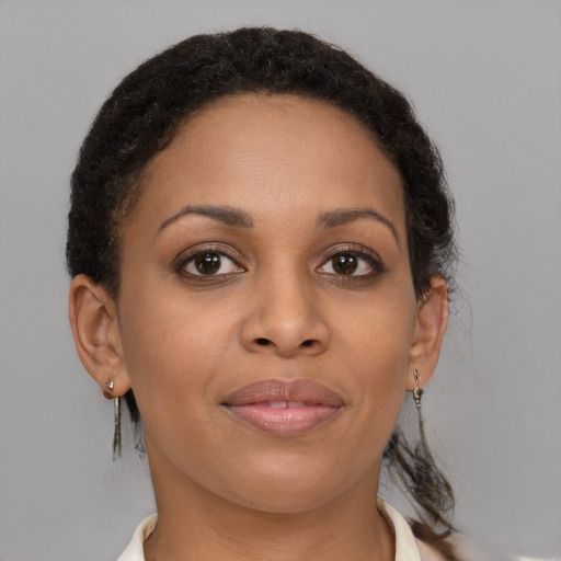 Joyful black young-adult female with short  brown hair and brown eyes