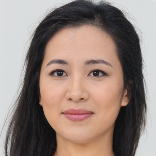 Joyful asian young-adult female with long  brown hair and brown eyes