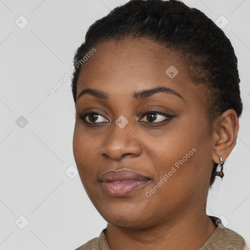 Joyful black young-adult female with short  black hair and brown eyes