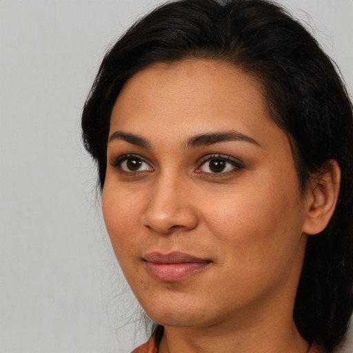 Joyful latino young-adult female with short  brown hair and brown eyes