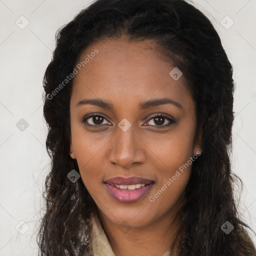 Joyful black young-adult female with long  brown hair and brown eyes