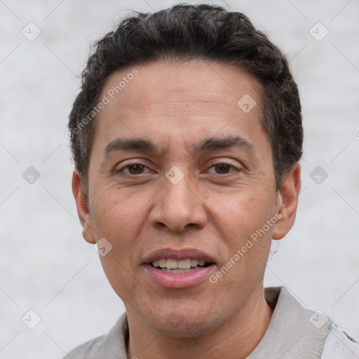 Joyful white adult male with short  brown hair and brown eyes