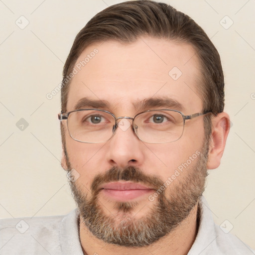 Joyful white adult male with short  brown hair and brown eyes