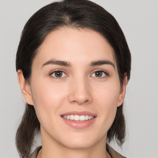 Joyful white young-adult female with medium  brown hair and brown eyes