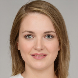 Joyful white young-adult female with medium  brown hair and green eyes