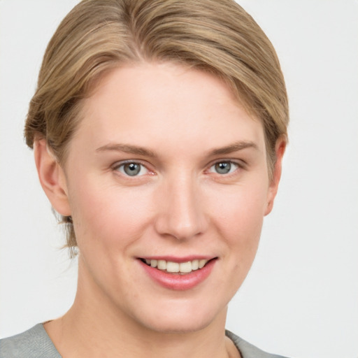 Joyful white young-adult female with short  brown hair and grey eyes