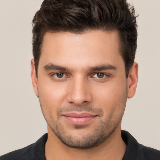 Joyful white young-adult male with short  brown hair and brown eyes