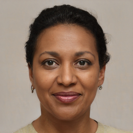 Joyful black adult female with short  brown hair and brown eyes