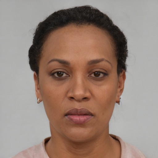 Joyful black adult female with short  black hair and brown eyes