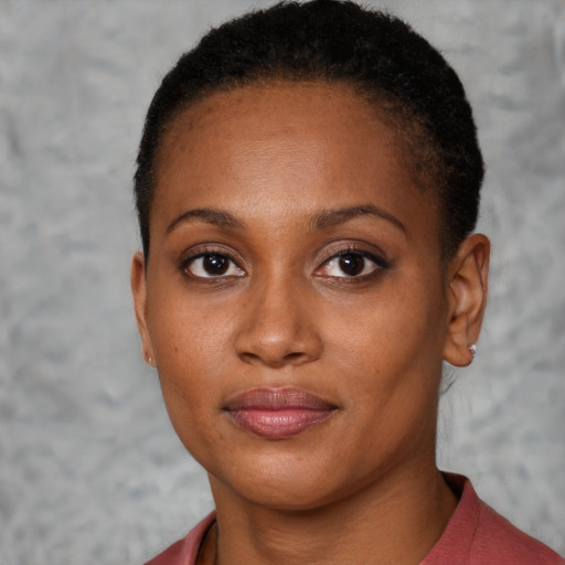 Joyful black young-adult female with short  brown hair and brown eyes