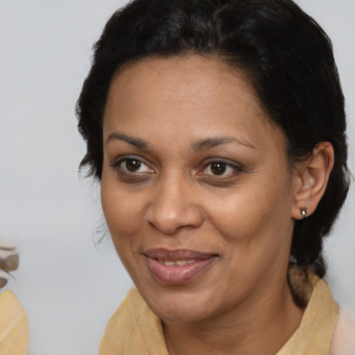 Joyful latino adult female with short  brown hair and brown eyes