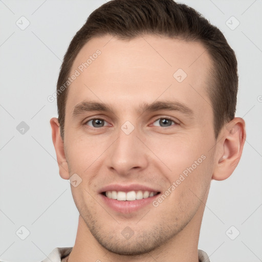 Joyful white young-adult male with short  brown hair and grey eyes