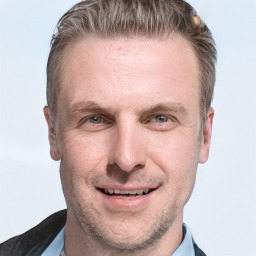 Joyful white adult male with short  brown hair and grey eyes