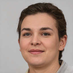 Joyful white adult female with short  brown hair and grey eyes