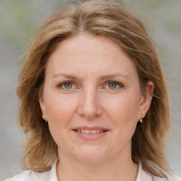 Joyful white adult female with medium  brown hair and blue eyes