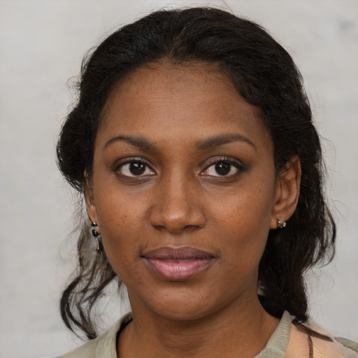 Joyful black young-adult female with medium  brown hair and brown eyes